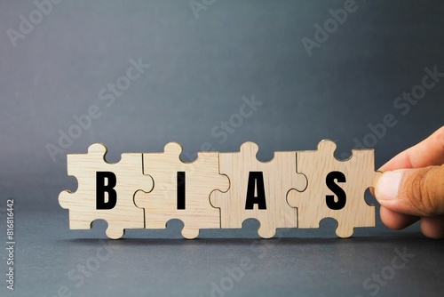 wooden puzzle with the word BIAS. inclination or prejudice for or against one person