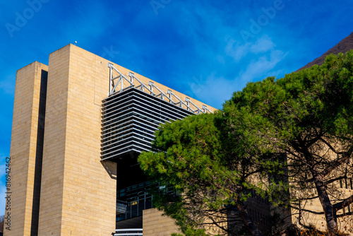 Modern Design Building Against Blue Sky and a Tree in Campione d'Italia, Lombardy, Italy.