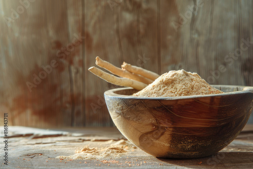 Organic ashwagandha powder in a wooden bowl with whole roots on a distressed wooden surface, backlit with warm sunlight