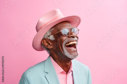 Portrait of a joyful afro-american elderly 100 years old man laughing isolated on pastel or soft colors background
