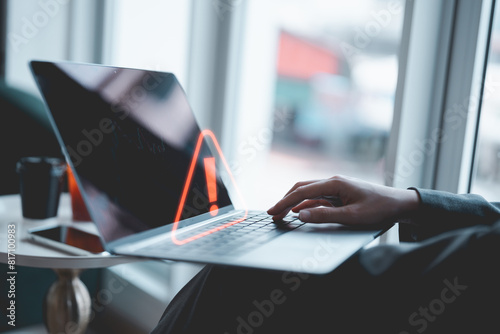 Businessman or programmer, developer using computer laptop with triangle caution warning sign for notification error and maintenance concept. Virus detected warning, Cybercrime protection. 