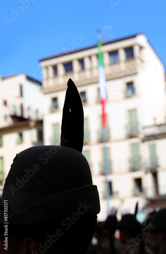 Black feather outline on Alpine hat and Italian flag