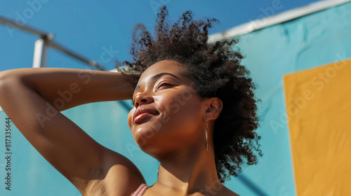 A woman with natural body hair, including in her armpits, is embracing her self-confidence and challenging societal norms about body hair removal.