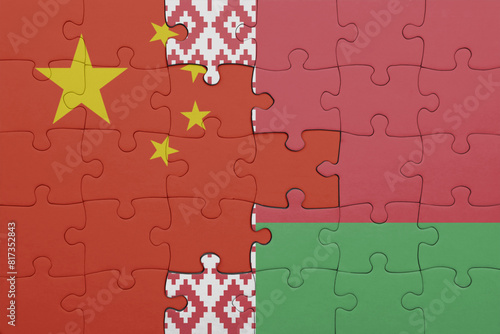 puzzle with the colourful national flag of belarus and flag of china .