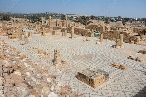 Partially reconstructed Roman Baths complex in ancient settlement of Sbeitla in Tunisia with well preserved mosaic floor and remnants of stone columns on sunny day