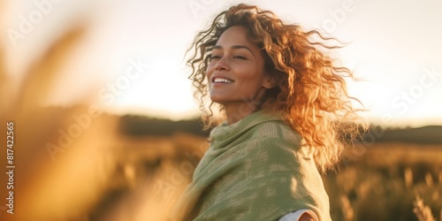 One beauty woman with happy and idyllic expression on face opening arm and enjoying sunset light in the field in scenic outdoor leisure activity. People loving life and healthy lifestyle concept. Life