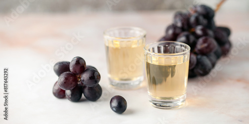 Traditional Georgian chacha, also known as grape vodka or Georgian grappa in shot glasses and fresh grapes