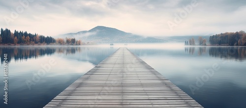 A serene lake with a wooden dock at the end surrounded by a peaceful walkway perfectly captured in this copy space image