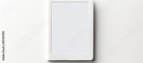 A modern e book reader is placed on a white background creating a flat lay composition with ample room for additional text