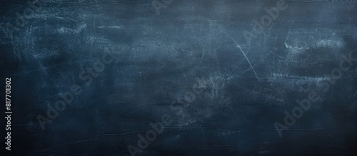 A copy space image of a dark blue chalkboard with traces of erasing creating a textured background