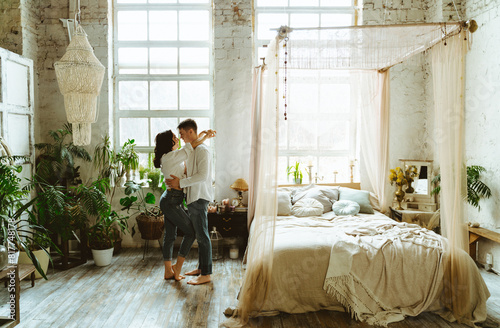 Young couple spending time and dancing and having lovely moments in their beautiful countryside house.