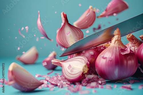 Cut shallots float in the air against a blue background.