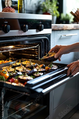 a woman takes eggplants out of the oven. selective focus