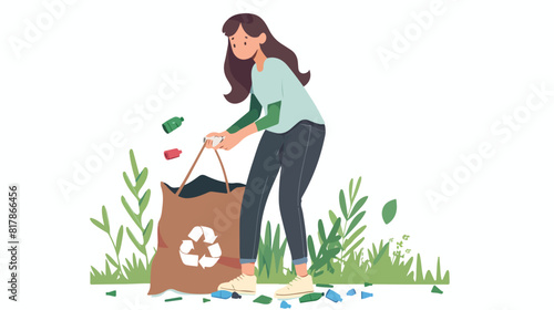 Female volunteer collecting litter into trash bag.