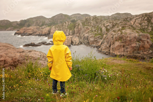 Family visiting the Lindesnes Fyr Lighthouse in Norway on a rainy cold day
