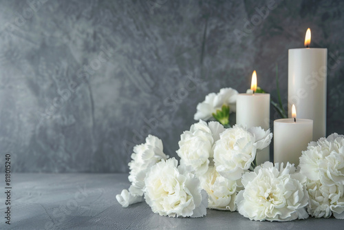 Tranquil condolence background with lit candles and delicate white flowers, symbolizing remembrance and peaceful farewells at funerals