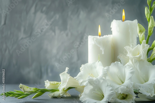 Elegant and somber condolence background featuring burning white candles and delicate gladiolus flowers against a muted gray backdrop