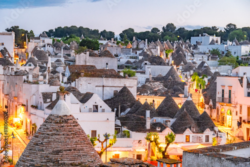 Trulli of Alberobello, Puglia, Italy. town of Alberobello with trulli houses among green plants and flowers