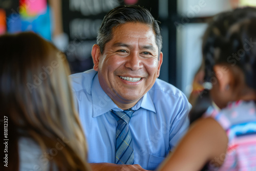 A Hispanic businessman, leading a mentorship program for at-risk youth in his community, providing guidance and support to help them overcome obstacles and achieve their full potential, his investment