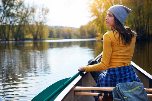 Woman, back and canoeing for water sport in nature, wellness hobby and single blade paddle for rowing. Vacation, relax and explore exercise on travel for summer holiday, canoe boat and trees on river