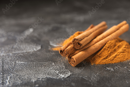 Ceylon cinnamon.Cinnamon sticks on a textured wooden background. Cinnamon roll and powder. Spicy spice for baking, desserts and drinks. Fragrant ground cinnamon. Close-up. Place for text. copy space