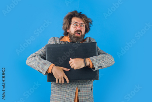 Portrait of confused businessman in suit with business briefcase. Astonished bearded man in eyeglasses with attache case. Stylish shocked business man, teacher or student in glasses with briefcase.
