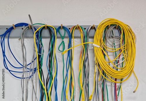 Colorful electrical cords wall hanging CAT5 Twisted pair cable computer networks. 