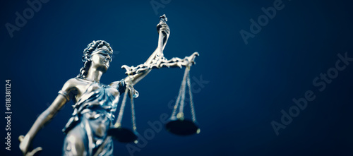 Lady Justice statue in law on blue background