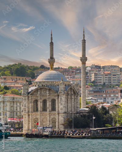 Istanbul, Turkey - May 8 2023: View from Bosphorus Strait overlooking Ortakoy Mosque, or Ortakoy Camii, aka Buyuk Mecidiye Camii, suited at the waterside of the Ortakoy pier square