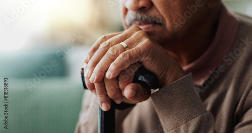 Old man, hands and walking stick in home for retirement grief for remember nostalgia, memory or thoughts. Male person, cane and wedding ring for elderly widower or unhappy, contemplating or lonely