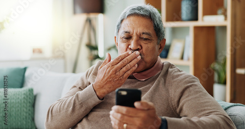 Senior man, video call and air kiss with phone on on sofa with online conversation and virtual in home. Connection, talking and happy old person on couch with smartphone for mobile app or discussion