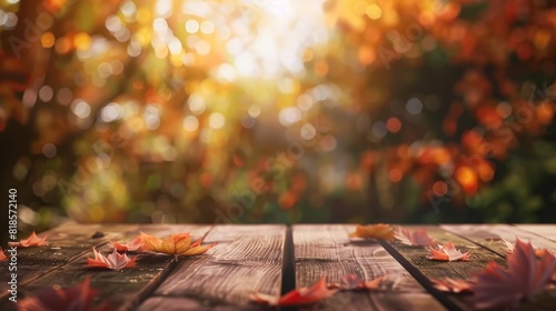Wooden table with orange fall leaves, autumn natural background