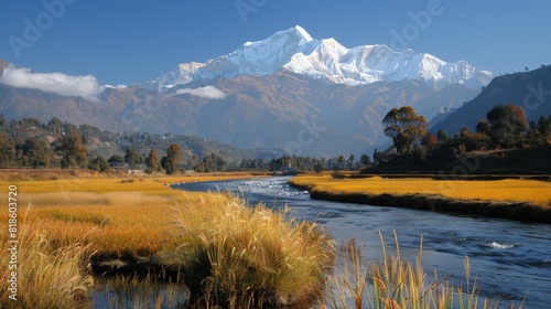 Beautiful himalayan mountain range at sunrise with lush rice terraces along a mountain river