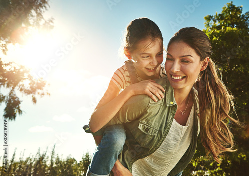 Smile, woman and kid with piggyback in forest for summer, travel holiday and outdoor bonding together. Blue sky, happy and mother with girl in park for child development, support or love on adventure