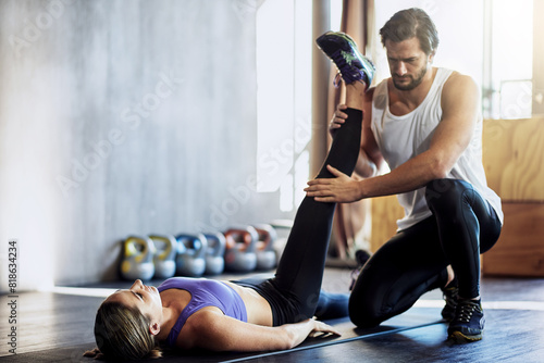 Physio, woman and legs stretching or helping for rehabilitation, personal training or mobility. Client, coaching and athlete for knee pain injury in workout centre for flexibility, gym or exercise