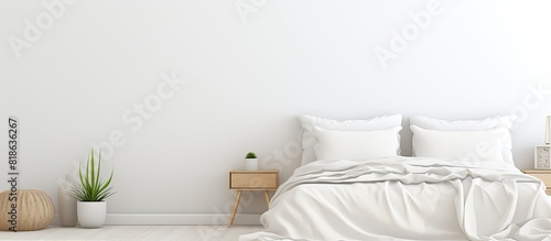 A white bedroom with a copy space image featuring a laptop peacefully resting on the bed symbolizing the concept of remote work