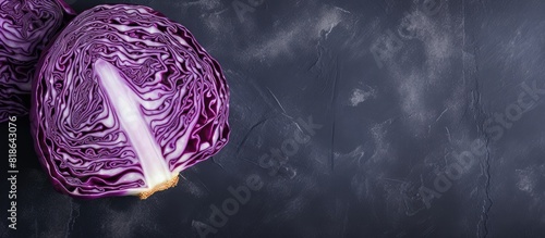 A top down view of red cabbage placed on a grey table with ample copy space available