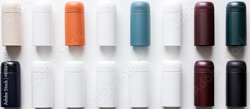 A variety of deodorant bottles neatly arranged on a white table with plenty of blank space for adding text. Creative banner. Copyspace image