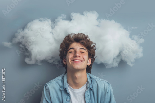 A young man is smiling and looking up at a cloud. Concept of happiness and contentment, as the man is enjoying the moment and taking in the beauty of the cloud