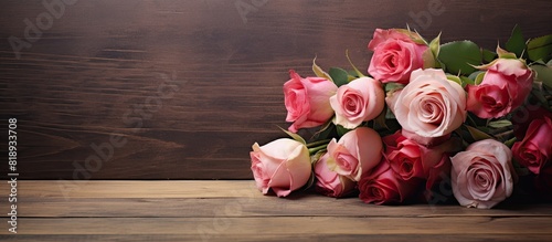 A beautiful bouquet of roses a symbol of love displayed on a wooden background in a retro style making it a stunning and sentimental gift Captured in a copy space image