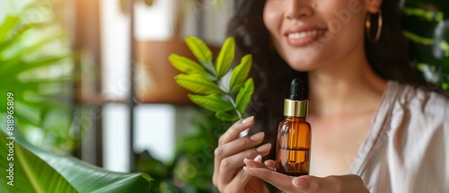 Woman holding a brown glass dropper bottle with green plants in the background, showcasing natural skincare products in a spa-like environment.