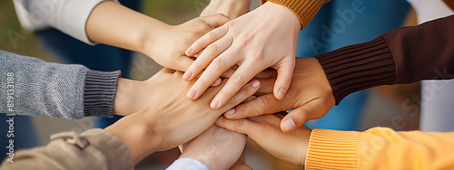 A circle of hands from office team members symbolizes unity, collaboration, teamwork, mutual support, and the collective strength of an office team.