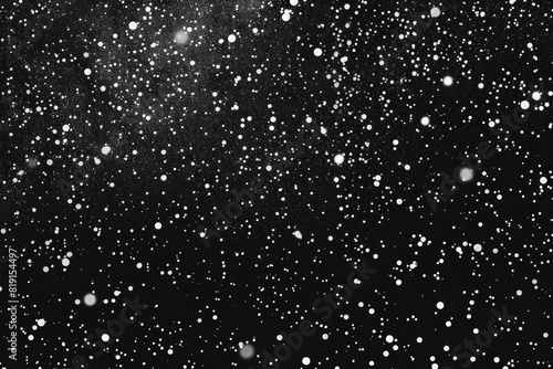 A serene black and white photo of falling snow. Suitable for winter themes and holiday designs