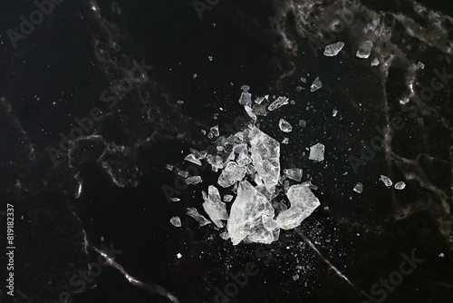 Lumps of alum on a black background. It is a mineral with clear, white crystals, odorless, astringent taste, ground into a white powder that resembles rock sugar.