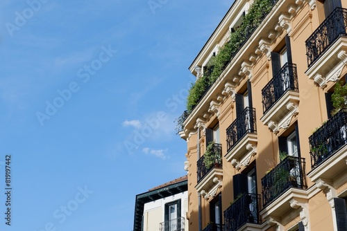 Corner of classical rich buildings with vivid greenery downtown madrid, spain. spanish vintage architecture