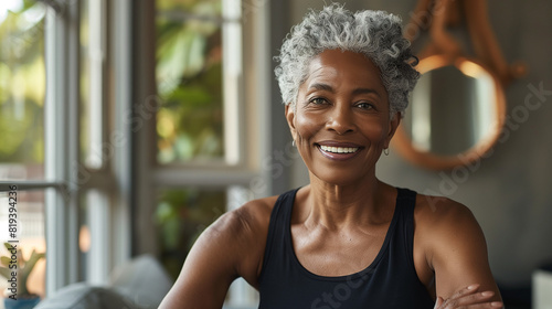 Professional Portrait of an active black African American mature woman smiling and doing fitness pilates & yoga meditation at her home gym