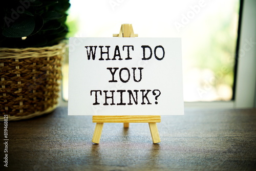 What do you think? text message on paper card with wooden easel