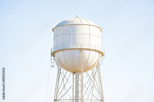 White water tower against a blue sky