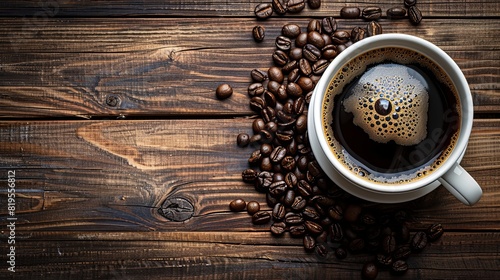 Overhead view of a steaming white cup of black coffee with a natural swirl, coffee beans on a wooden background