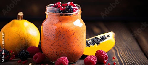 Close up of a berry smoothie with pumpkin and chia seeds in a glass jar on a rustic wood background with selective focus for a copy space image conveying a concept of detox diet well being and weight